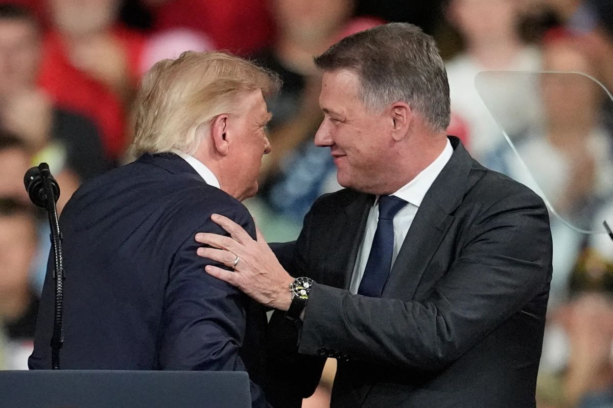 Audi CEO Gernot Döllner appears on stage with Trump at a Republican campaign rally to announce a new car factory in Georgia